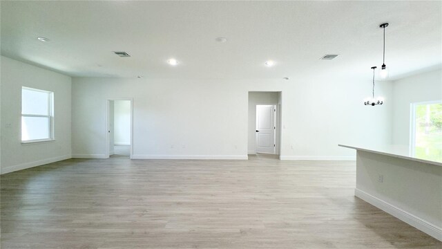 2498 W Magenta Dr, Citrus Springs, FL 34434 - spare room with recessed lighting, light wood-type flooring, and a chandelier