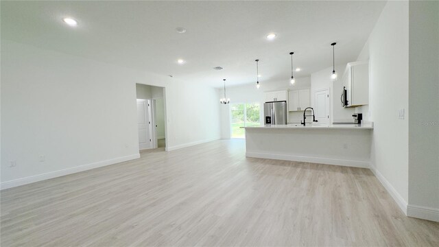 2498 W Magenta Dr, Citrus Springs, FL 34434 - unfurnished living room featuring light wood-type flooring and recessed lighting