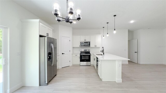 2498 W Magenta Dr, Citrus Springs, FL 34434 - kitchen with stainless steel appliances, light wood-type flooring, a chandelier, a peninsula, and light countertops