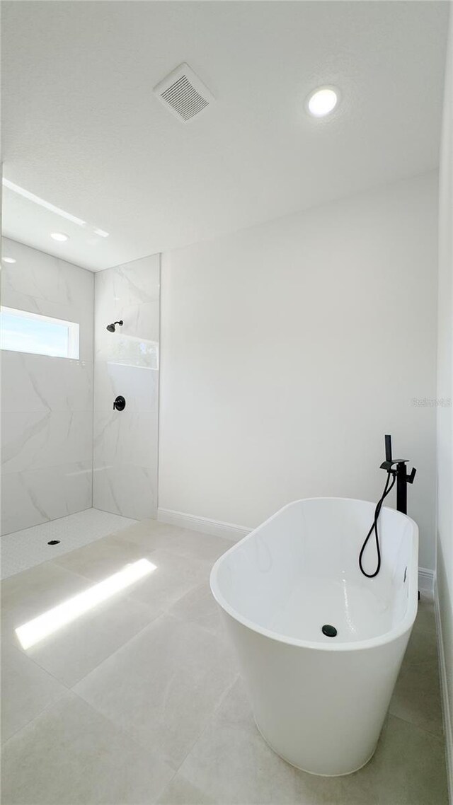 2498 W Magenta Dr, Citrus Springs, FL 34434 - bathroom with a marble finish shower, a freestanding tub, and recessed lighting