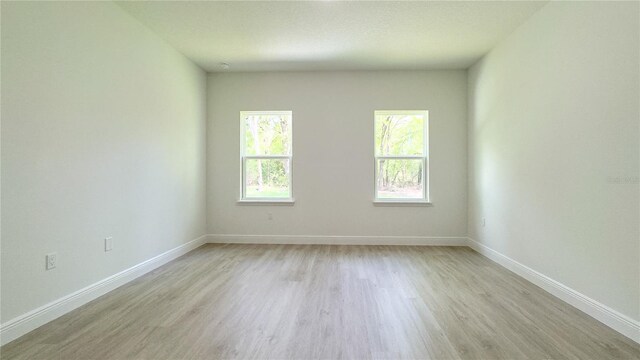 2498 W Magenta Dr, Citrus Springs, FL 34434 - empty room featuring light wood-type flooring and baseboards
