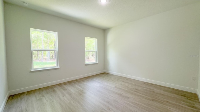 2498 W Magenta Dr, Citrus Springs, FL 34434 - spare room featuring light wood-type flooring and a smoke detector