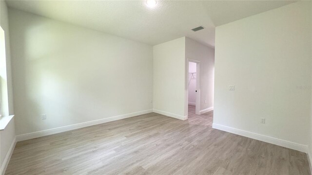 2498 W Magenta Dr, Citrus Springs, FL 34434 - spare room featuring light wood-style floors and baseboards
