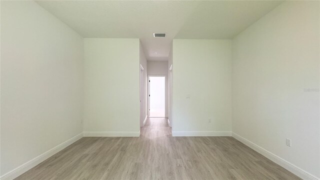 2498 W Magenta Dr, Citrus Springs, FL 34434 - empty room featuring light wood finished floors and baseboards