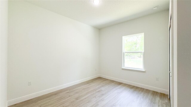 2498 W Magenta Dr, Citrus Springs, FL 34434 - unfurnished room with light wood-style floors and a smoke detector