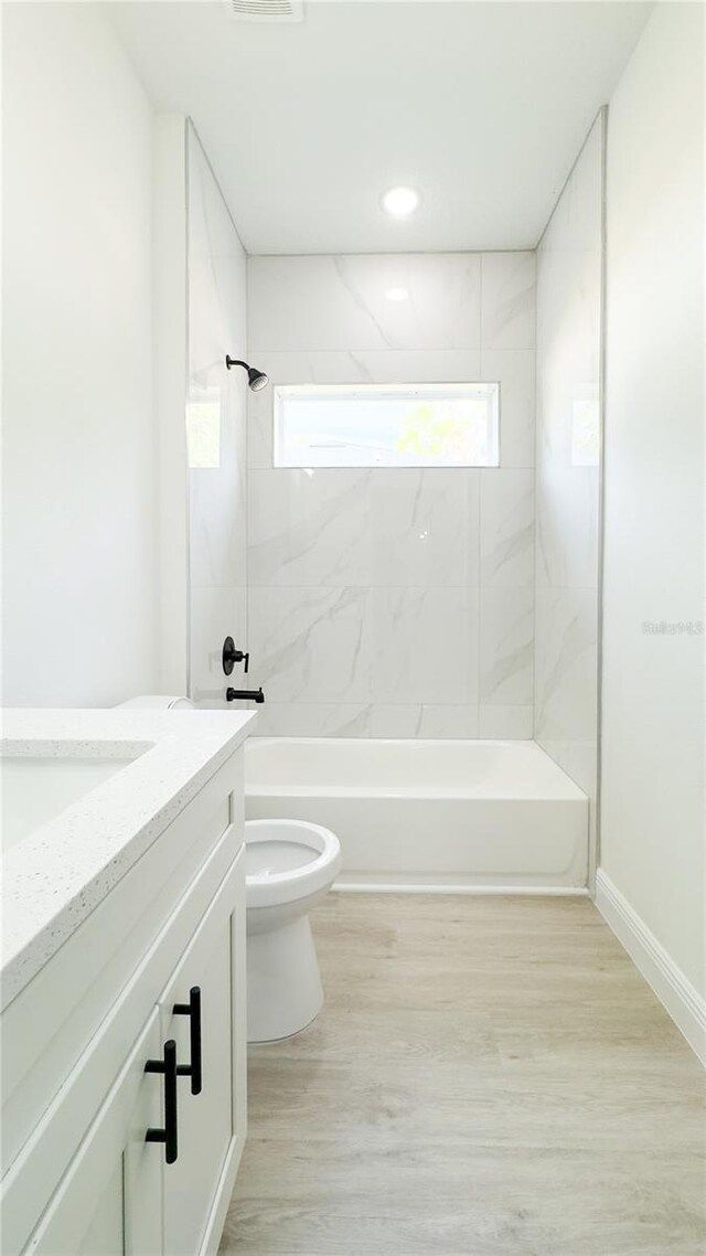 2498 W Magenta Dr, Citrus Springs, FL 34434 - full bath with vanity, shower / tub combination, wood finished floors, and recessed lighting