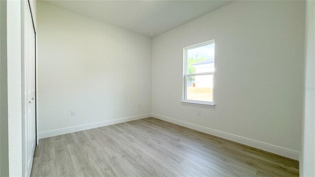 2498 W Magenta Dr, Citrus Springs, FL 34434 - spare room featuring light wood-style flooring and baseboards