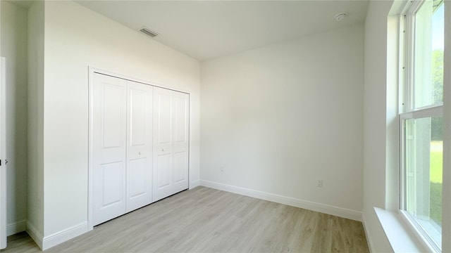 2498 W Magenta Dr, Citrus Springs, FL 34434 - unfurnished bedroom with light wood-style floors and a closet