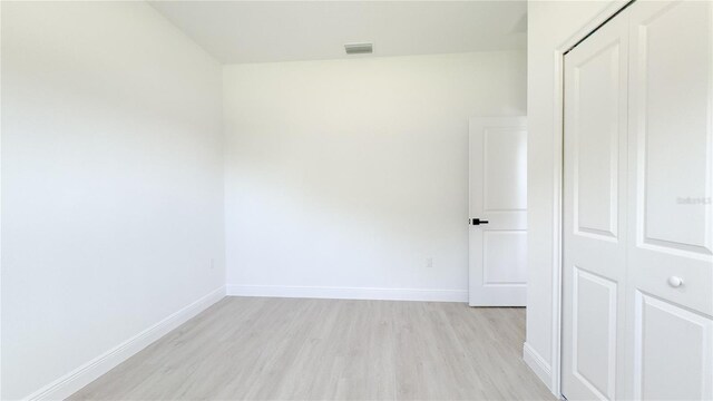 2498 W Magenta Dr, Citrus Springs, FL 34434 - spare room with light wood-style flooring and baseboards