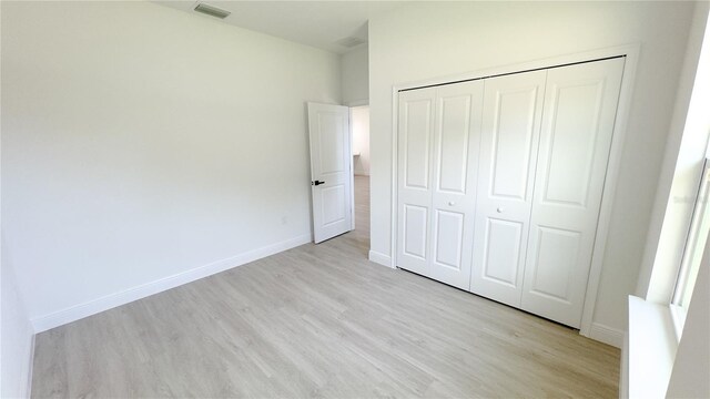 2498 W Magenta Dr, Citrus Springs, FL 34434 - unfurnished bedroom with light wood-type flooring and a closet