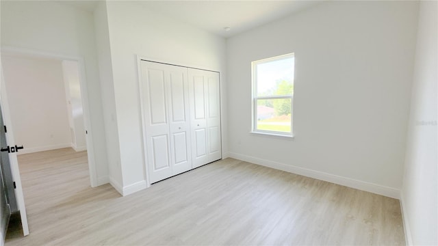 2498 W Magenta Dr, Citrus Springs, FL 34434 - unfurnished bedroom with light wood-style floors and a closet