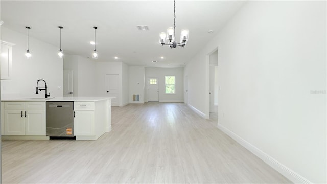 2498 W Magenta Dr, Citrus Springs, FL 34434 - kitchen with stainless steel dishwasher, open floor plan, a chandelier, light wood-type flooring, and light countertops