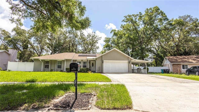 5177 Chesapeake Ave, Orlando, FL 32808 - single story home with driveway, an attached garage, roof mounted solar panels, and stucco siding