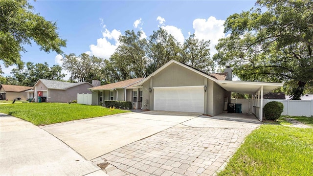 5177 Chesapeake Ave, Orlando, FL 32808 - view of front facade with driveway, a chimney, a garage, and stucco siding
