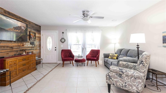 5177 Chesapeake Ave, Orlando, FL 32808 - living room featuring wooden walls, a ceiling fan, light tile patterned floors, and an accent wall