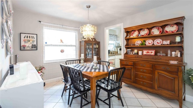 5177 Chesapeake Ave, Orlando, FL 32808 - dining room featuring a chandelier and light tile patterned floors