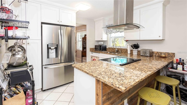 5177 Chesapeake Ave, Orlando, FL 32808 - kitchen with stainless steel appliances, wall chimney range hood, white cabinetry, and light stone counters