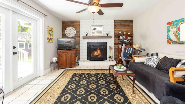 5177 Chesapeake Ave, Orlando, FL 32808 - living area with a ceiling fan, an accent wall, a brick fireplace, light tile patterned floors, and wood walls