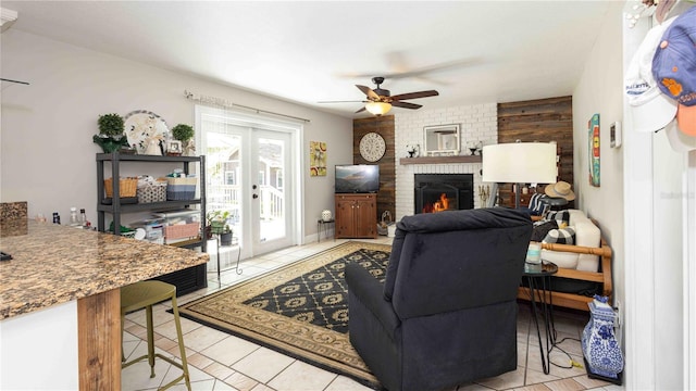 5177 Chesapeake Ave, Orlando, FL 32808 - living room featuring light tile patterned floors, ceiling fan, and a brick fireplace