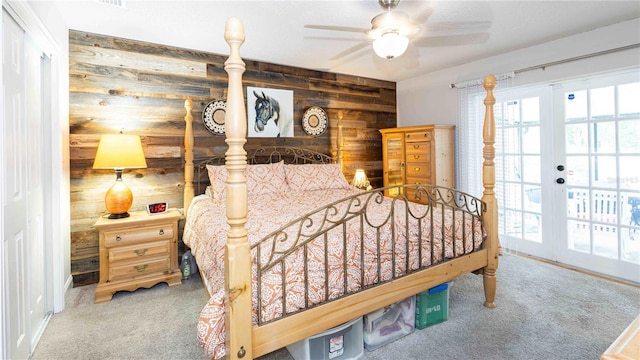 5177 Chesapeake Ave, Orlando, FL 32808 - carpeted bedroom with wood walls, multiple windows, a ceiling fan, and access to exterior