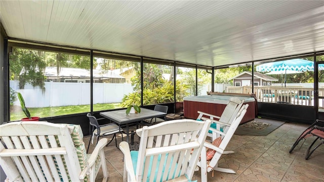 5177 Chesapeake Ave, Orlando, FL 32808 - sunroom / solarium with a hot tub and outdoor dining space