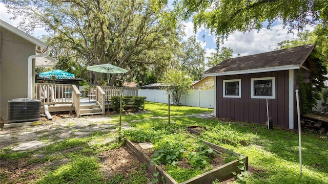 5177 Chesapeake Ave, Orlando, FL 32808 - fenced backyard featuring a vegetable garden, a wooden deck, and an outdoor structure
