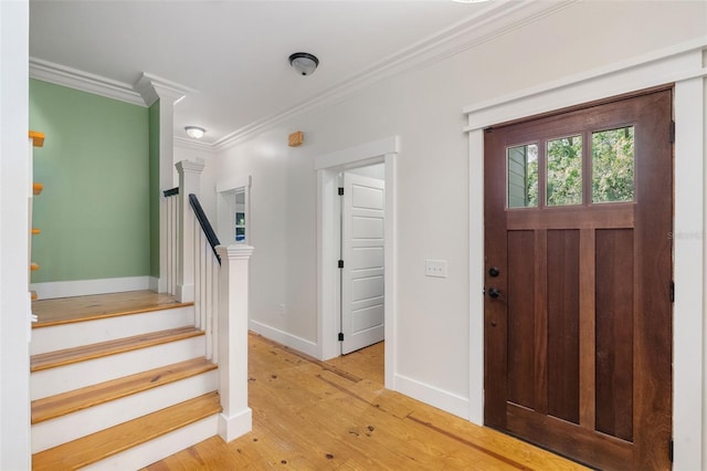 408 W Pearl St, Minneola, FL 34715 - entrance foyer with crown molding, light wood-style flooring, and stairs
