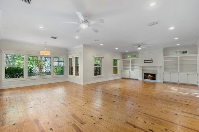 408 W Pearl St, Minneola, FL 34715 - unfurnished living room with a ceiling fan, ornamental molding, recessed lighting, a high end fireplace, and light wood-type flooring