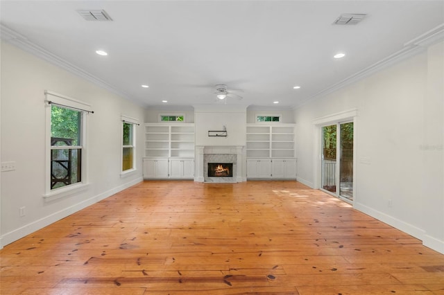 408 W Pearl St, Minneola, FL 34715 - unfurnished living room with crown molding, a ceiling fan, light wood finished floors, recessed lighting, and a premium fireplace