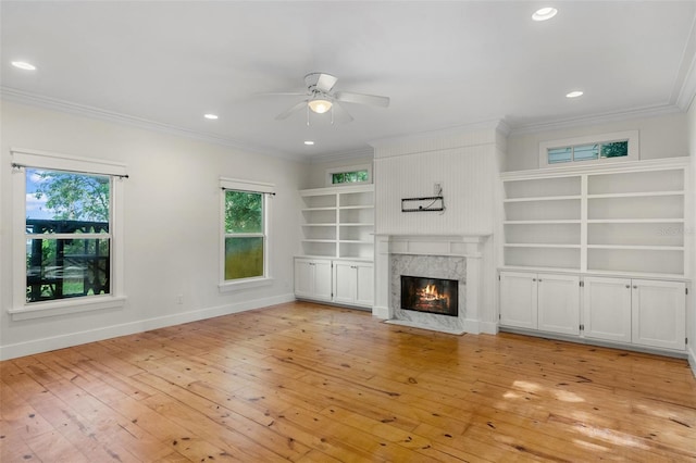 408 W Pearl St, Minneola, FL 34715 - unfurnished living room featuring crown molding, a ceiling fan, light wood-style flooring, a high end fireplace, and recessed lighting