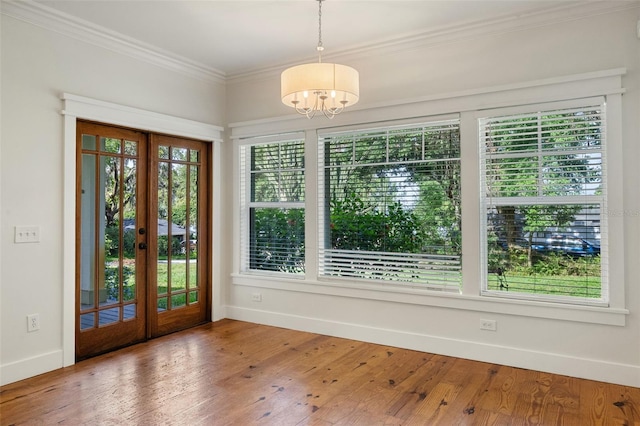 408 W Pearl St, Minneola, FL 34715 - entrance foyer with french doors, a chandelier, ornamental molding, and wood finished floors