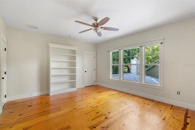 408 W Pearl St, Minneola, FL 34715 - empty room with ceiling fan, wood-type flooring, and built in shelves