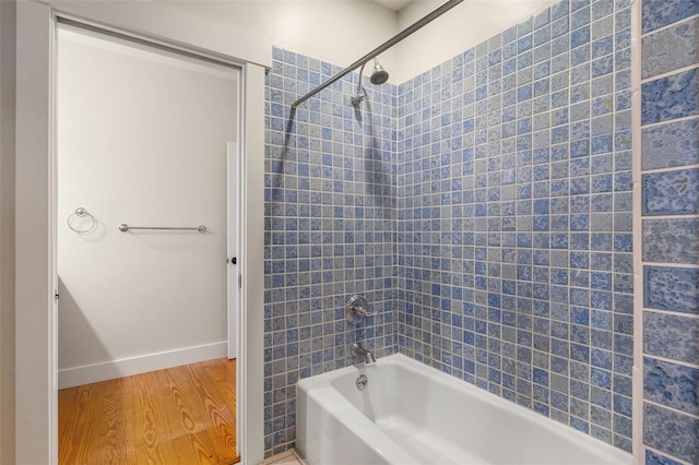 408 W Pearl St, Minneola, FL 34715 - bathroom with wood finished floors and shower / bathtub combination