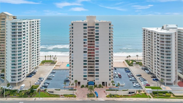 2947 S Atlantic Ave Unit 601, Daytona Beach, FL 32118 - view of apartment building / complex featuring view of water and beach and uncovered parking
