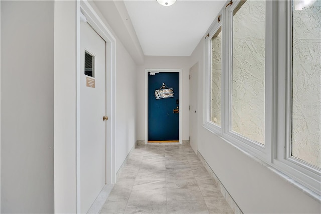 2947 S Atlantic Ave Unit 601, Daytona Beach, FL 32118 - hallway with baseboards and light marble finish flooring