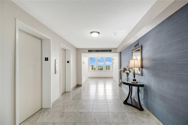2947 S Atlantic Ave Unit 601, Daytona Beach, FL 32118 - hallway with an accent wall, elevator, and light tile patterned floors