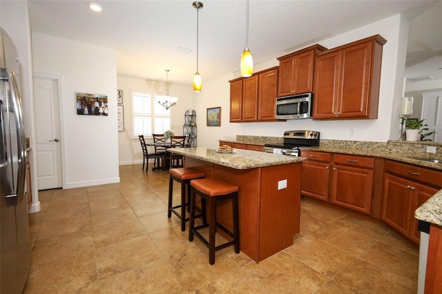 3574 La Jolla Dr, Clermont, FL 34711 - kitchen featuring appliances with stainless steel finishes, a chandelier, light stone countertops, a kitchen breakfast bar, and pendant lighting