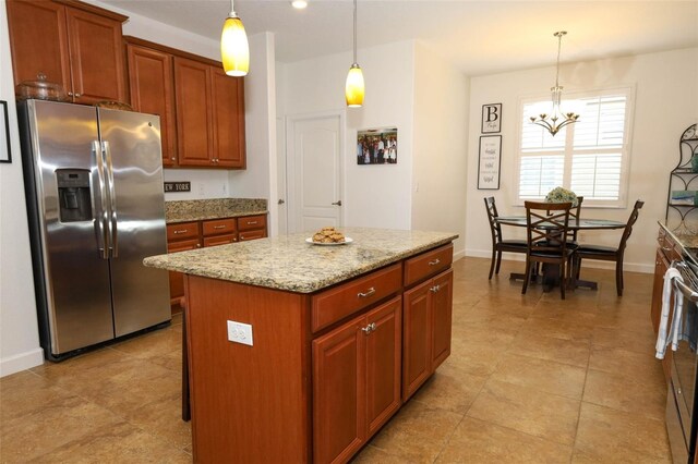3574 La Jolla Dr, Clermont, FL 34711 - kitchen with stainless steel fridge with ice dispenser, a chandelier, decorative light fixtures, a center island, and light stone counters