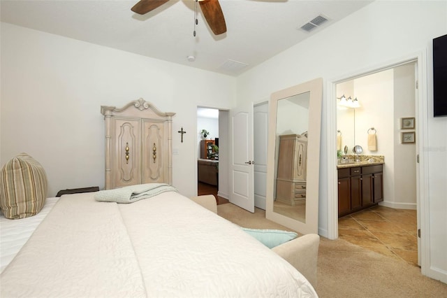 3574 La Jolla Dr, Clermont, FL 34711 - bedroom with light carpet, ensuite bathroom, and ceiling fan
