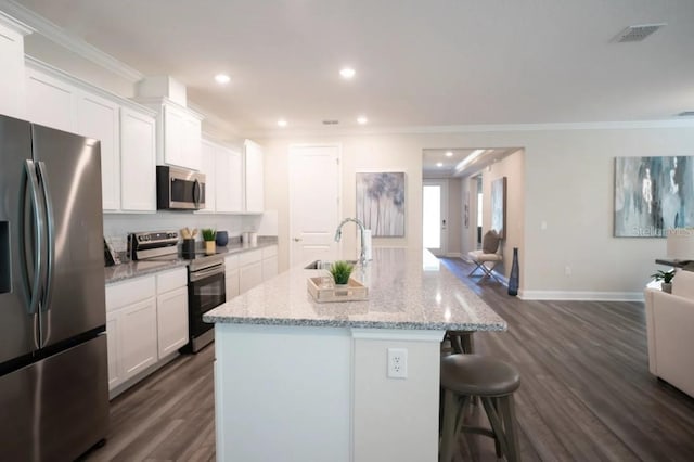 351 S Sunset Ave, Mascotte, FL 34753 - kitchen featuring appliances with stainless steel finishes, a sink, ornamental molding, dark wood-type flooring, and open floor plan