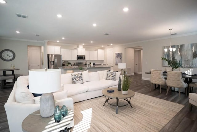 351 S Sunset Ave, Mascotte, FL 34753 - living room with ornamental molding, recessed lighting, wood finished floors, baseboards, and a chandelier