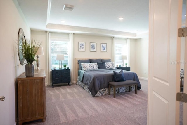 351 S Sunset Ave, Mascotte, FL 34753 - bedroom featuring light colored carpet, multiple windows, a raised ceiling, and recessed lighting