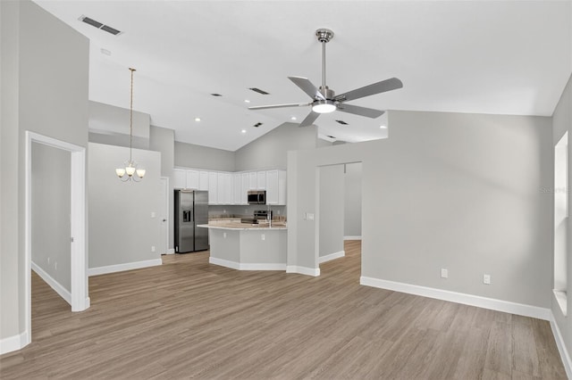 632 Bridge Creek Blvd, Ocoee, FL 34761 - kitchen with appliances with stainless steel finishes, open floor plan, ceiling fan, light countertops, and a chandelier