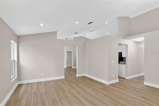 632 Bridge Creek Blvd, Ocoee, FL 34761 - spare room featuring vaulted ceiling, light wood finished floors, and recessed lighting