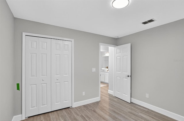632 Bridge Creek Blvd, Ocoee, FL 34761 - unfurnished bedroom featuring light wood finished floors and a closet