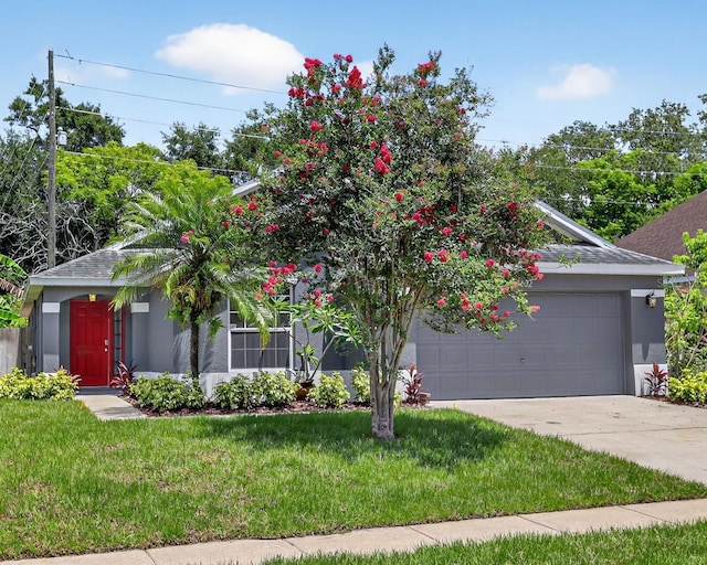 632 Bridge Creek Blvd, Ocoee, FL 34761 - view of property hidden behind natural elements with stucco siding, an attached garage, concrete driveway, and a front yard