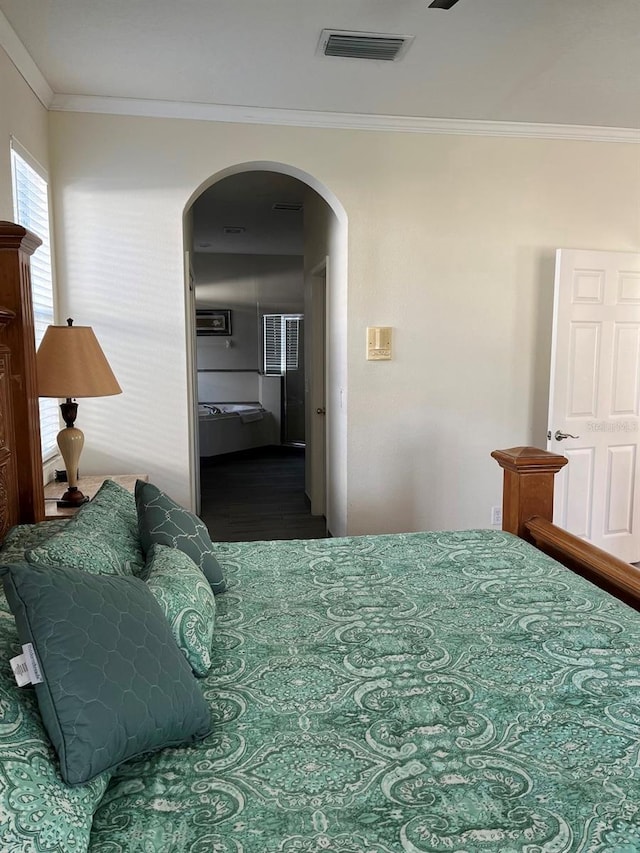 160 Calabay Parc Blvd, Davenport, FL 33897 - bedroom with arched walkways, crown molding, and wood finished floors