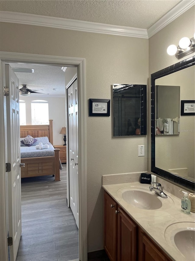 160 Calabay Parc Blvd, Davenport, FL 33897 - full bath featuring a textured ceiling, crown molding, wood finished floors, double vanity, and a ceiling fan