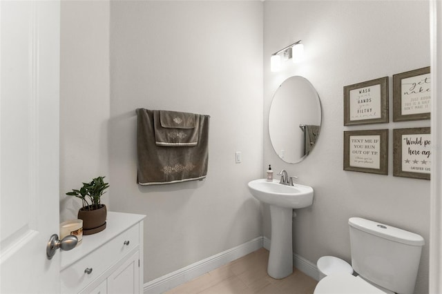 1787 White Feather Loop, Oakland, FL 34787 - bathroom with toilet, baseboards, and a sink