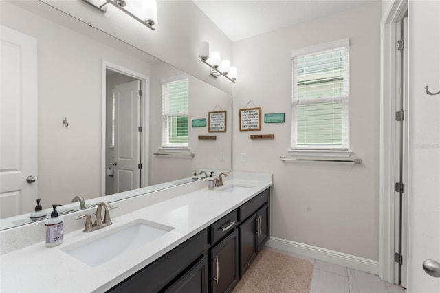 1787 White Feather Loop, Oakland, FL 34787 - bathroom featuring double vanity and baseboards